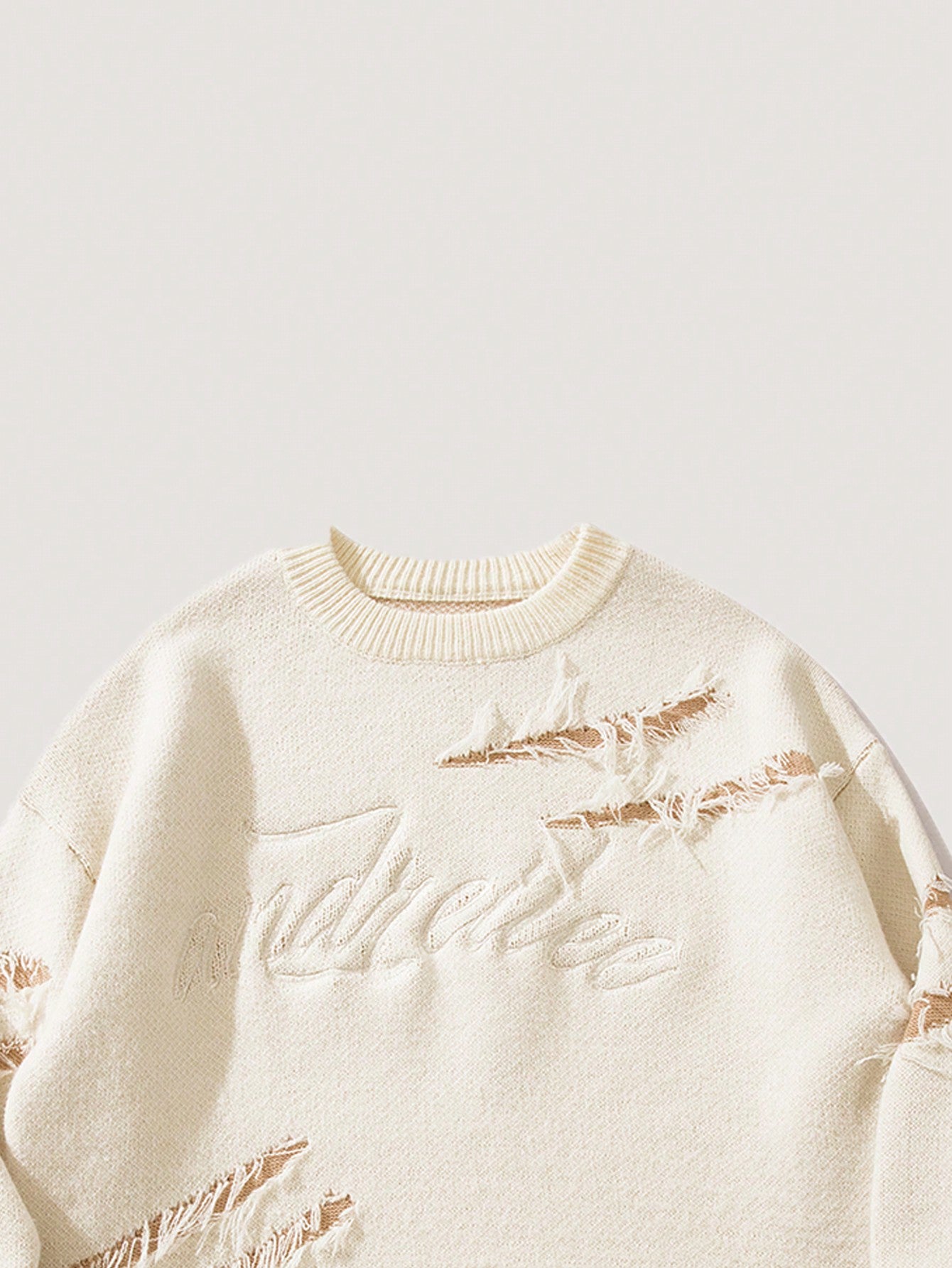 ANDREILEE EMBROIDERED LETTERS, TORN HOLES, TASSEL SWEATER